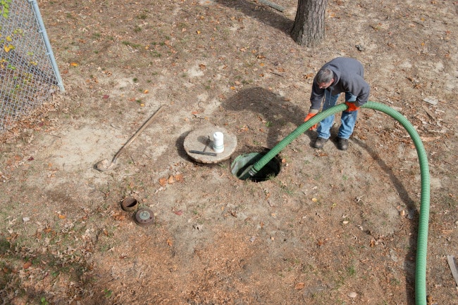man cleans home septic tank
