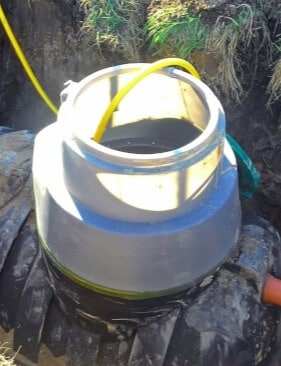 plumbing drain pipe is being connected to septic tank for waste treatment