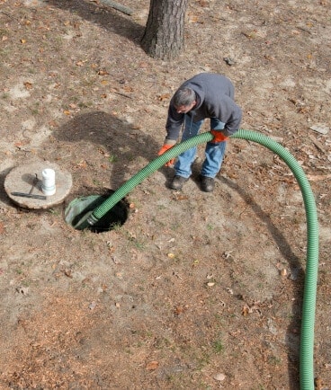 man cleans home septic tank