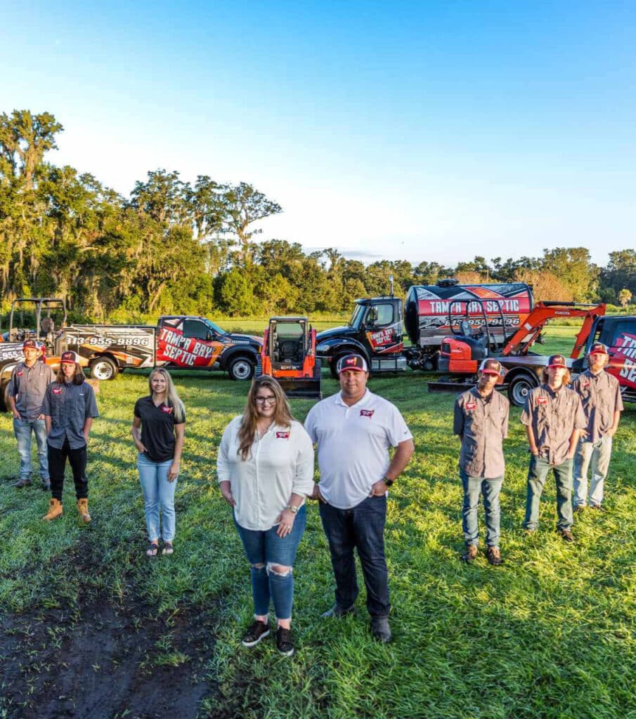 tampa bay septic team in front of vehicles